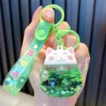Cute green Maneki-neko lucky cat keychain with liquid quicksand glitter and HAPPY strap - Green