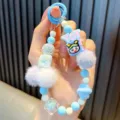 Dragonne de téléphone perlée bleu et blanc avec pompons et breloque abeille YOT - Style Pompon Bleu