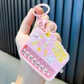 Handheld mini pink piano keychain featuring cute rabbit design and numbered music keys - Pink