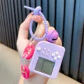 Mini purple retro handheld game console keychain with decorative bell and pink chain - Purple