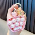 Mini pink Whac-A-Mole electronic game keychain toy for kids with glowing light feature - Pink