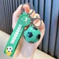 Trendy green soccer ball keychain with GOOOOOAL silicone strap and athlete charm - Green