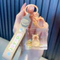 Simpatico portachiavi capibara con sabbie mobili liquide, cinturino beige JOYFUL e metallo - Stile Seduto