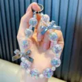 Cinturino portachiavi di perle di cristallo con sfere iridescenti e fiocchi d'argento per borse. - Nero