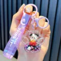Purple panda quicksand keychain with liquid stars and a glittery strap pendant - Cat Paw