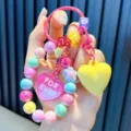 Colorful acrylic beaded keychain with yellow and pink heart charms for bag accessory. - Yellow