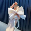 Handmade cream ribbon bow keychain with elegant pearl beaded strap for bag pendants - White