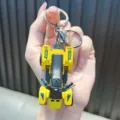Yellow mini beach ATV toy keychain featuring black seat and wild print for bag charms - Yellow