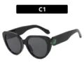 Luxe zwarte cat-eye zonnebril met een groen edelsteenaccent op de brilpoten voor dames - C1 / Glanzend Zwart Grijs Glas