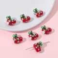 Detailed view of red polka dot heart beads for DIY jewelry making on a pink background - Christmas Sock Pendant