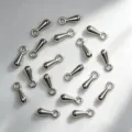 Detailed macro view of small silver alloy teardrop charms for DIY jewelry making accessories - Water Drop Dangle / 30 Pieces/Pack (2x7mm) / Silver