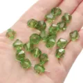 Sparkling 10mm faceted green crystal bicone beads for DIY jewelry making held in hand - Diamond Pattern / 10mm Approx 46 Pcs / Light Green