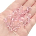 Handheld view of 10mm light pink faceted crystal bicone beads for DIY handmade jewelry crafting - Diamond Pattern / 10mm Approx 46 Pcs / Pink