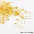 Detalle de 100 imperdibles de seguridad dorados tipo calabaza para marcadores de punto - 100 Unidades/Paquete / Dorado