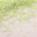 Close-up macro view of iridescent light green crushed glass stones for DIY craft filling - Yellow-Green