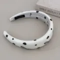 Detailed view of a white padded headband featuring elegant black rose and bow prints - Headband / Beige Bow