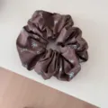 Detailed macro view of a brown oversized scrunchie with light blue bow print patterns - Scrunchie / Coffee Brown Bow