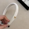 Elegant white velvet narrow headband featuring a delicate small gold bow charm detail - Narrow Bow Headband / Beige