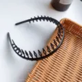 Macro detail showing the durable long teeth of a black non-slip plastic hair hoop. - Matte Black