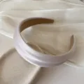 Close-up of French style wide satin headband with high top design for women. - Shiny Silk Headband / Beige