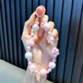 Handmade pink beaded phone charm with cute iridescent bunny and star shapes for women - Pink