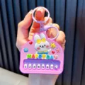 Cute pink rabbit mini piano keychain pendant with colorful buttons and Happy Day text - Purple