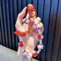 Handgemaakt telefoonkoord in dopaminestijl met een schattige rode vliegtuig hanger - Rood