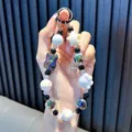 Handmade iridescent rabbit beaded phone strap keychain with paw and star charms for phone case - Black