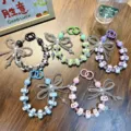 Set of 5 colorful handmade beaded phone charms with bows and cute character beads - Transparent Bowknot Style (With Tether Tab)