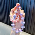 Handmade purple beaded moon girl keychain with floral and bow charms for bags and phones - Purple
