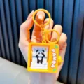 Cute yellow panda flip-book animation machine keychain pendant for bags and car keys - Yellow