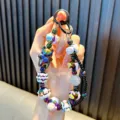 Beaded cartoon bear phone charm with iridescent metallic finish and colorful beads - Black