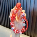 Red beaded phone charm with cartoon bear and heart pattern beads - Red