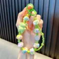 Handmade green beaded bear phone charm with colorful resin beads and a glitter ball - Green