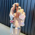 Colorful pixel heart beaded phone strap with cute hand-painted cow and flower charms - Black