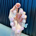 Cute iridescent crystal butterfly beaded phone strap with pink heart charms for women. - Pink