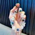 Iridescent beaded phone strap with butterfly charms and crystal geometric beads - Black