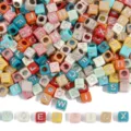 Detailed macro view of colorful square acrylic alphabet beads for DIY jewelry making. - Solid Color + Silver Font