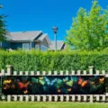 Dreamy butterfly garden banner with green vines and vibrant butterflies on a fence - 30x120cm (With Holes and Rope)