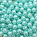 Macro shot of light teal round ABS acrylic pearl beads with holes for DIY jewelry - 4mm (1000 Pieces/Pack) / Lake Blue