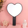 Aesthetic black heart-shaped handheld makeup mirror with handle for daily vanity use - 13cm*18cm / Black