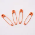 Set of four bright orange painted metal safety pins for DIY crafts and garment tags - Orange