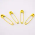 Set of four vibrant yellow painted metal safety pins for clothing DIY and handicraft use - Yellow