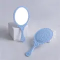 Vintage light blue hand mirror with intricate floral pattern on the back for makeup - 9cm*19cm / Blue