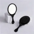 Vintage black handheld makeup mirror with ornate floral carvings and antique handle style - 9cm*19cm / Black