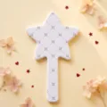 White star-shaped handheld makeup mirror with black quilted pattern and star detail - Star Grid Pattern