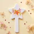 Star-shaped white handheld makeup mirror featuring a vibrant orange floral print design - Orange Leaf Floral