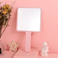 Elegant pink square handheld makeup mirror with a long ergonomic handle for easy grip - Pink