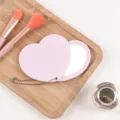 Compact heart-shaped rotating portable vanity mirror with hanging chain in soft pink color - 8*9 Rotating Heart Mirror / Pink