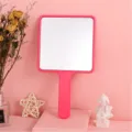 Square handheld makeup mirror in vibrant pink plastic finish for personal vanity use - Rose Red